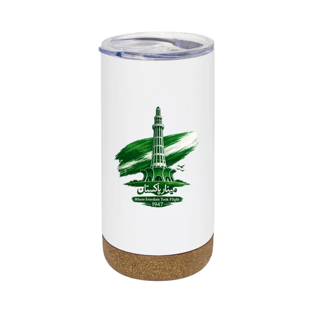 A white insulated tumbler with a clear lid and a cork base, featuring a green graphic of a minaret tower with the text 'Makkah Islamabad' and 'Where Freedom Wind Rises 1947'. The tumbler is centered on a solid light green background.