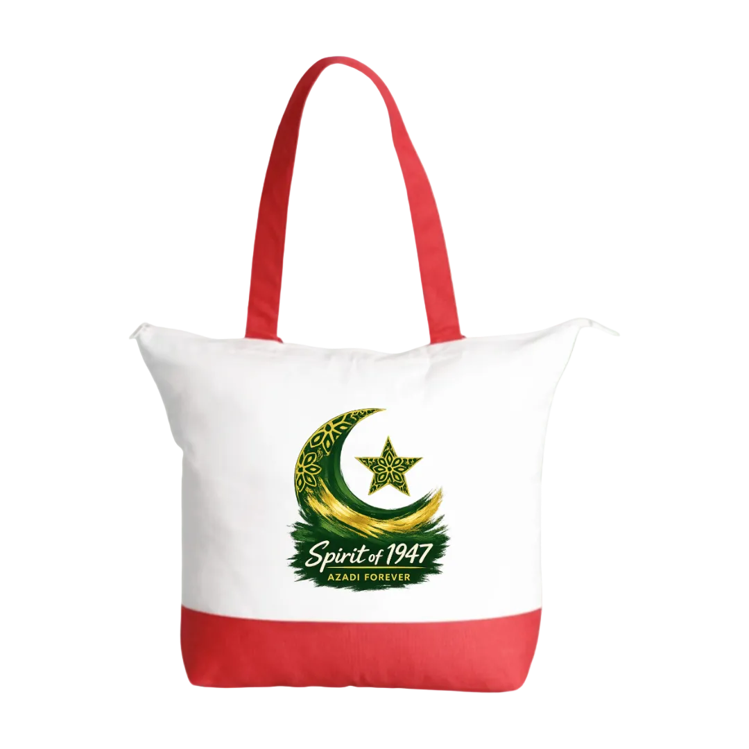 A white canvas tote bag with red handles and a red bottom panel, featuring a green and gold crescent moon and star graphic with the text 'Spirit of 1947' and 'AL-AQSA FOREVER' printed on the front, set against a solid light green background.