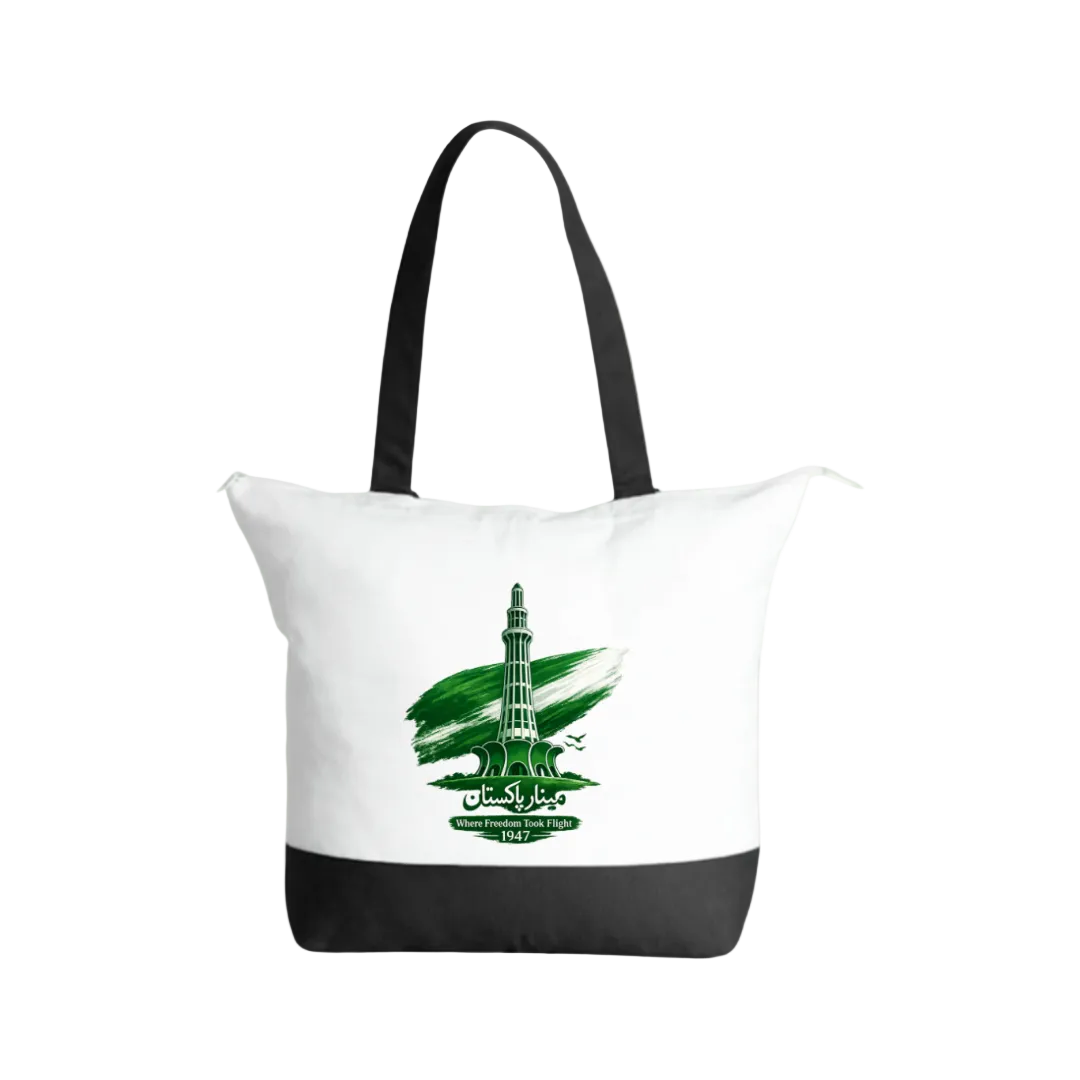 A white canvas tote bag with black handles and a black bottom panel, featuring a green graphic of the Taj Mahal with the text 'Taj Mahal Agra' on the front, set against a solid light green background.