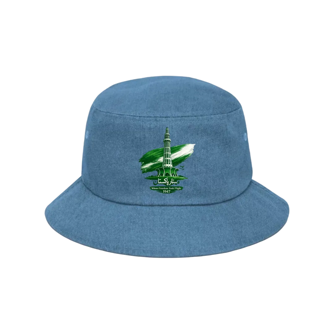 A blue bucket hat with an embroidered emblem of the Taj Mahal on a green and white flag, set against a solid light green background.