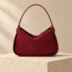 Burgundy bag on an ivory plinth