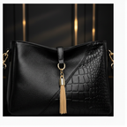 Detail – gold tassel and crocodile texture