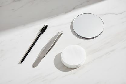 Orial tweezer flat-lay on marble surface with beauty accessories