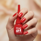 Woman with red nails holding Orial Gel red nail polish bottle