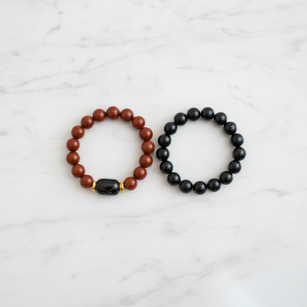 Red Jasper and Black Onyx Bracelet Set flat lay on marble - square