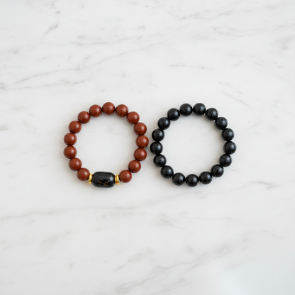 Red Jasper and Black Onyx Bracelet Set flat lay on marble - square
