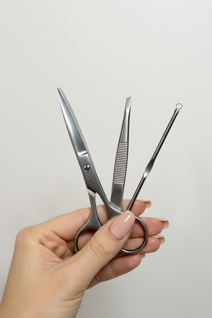 Elegant hands holding Orial beauty tools set – scissors, tweezer and blackhead extractor