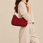 Model carrying the red bag with one strap